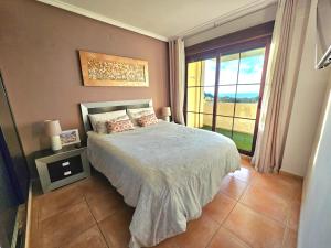 a bedroom with a bed and a large window at Sea View Chalet - Altea Hills in Altea