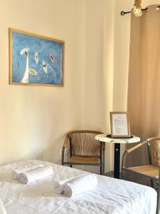 a room with a bed and a laptop on a table at Rocky Stays - Argostoli Central Studio in Argostoli