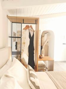 a dress hanging on a rack in a bedroom at Paxos Dream House in Vlachopoulátika