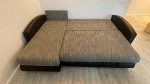 a bed in a room with twoupholstery at Central Boulevard Apartment in Šiauliai