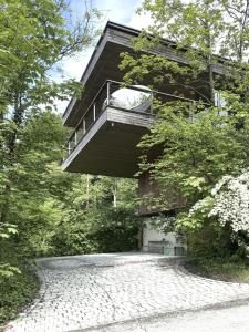 a building with a balcony on the side of a road at Haus am Felsen, Ferien in Vorarlberger Architektur in Bregenz