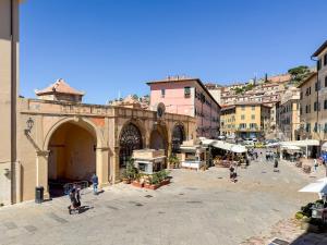 a group of people walking around a city street at Piazza 49 - HelloElba in Portoferraio