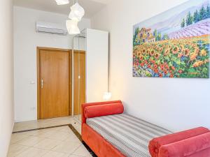 a room with a couch and a painting on the wall at Piazza 49 - HelloElba in Portoferraio