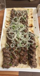 a plate of food with meat and onions on it at Harutyunyants Hall in Ijevan
