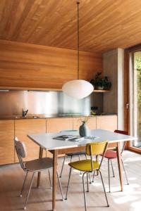 a dining room with a table and chairs at Haus am Felsen, Ferien in Vorarlberger Architektur in Bregenz