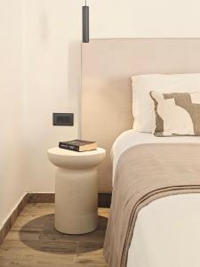 a bedroom with a bed and a book on a table next to a bed at Paxos Dream House in Vlachopoulátika