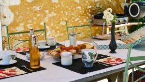 a table with food and bottles of beer and bread at La Belle Chartreuse in Manciet