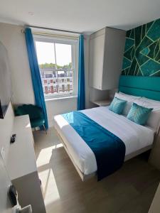a bedroom with a large bed and a window at Seven Paddington in London