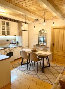 a kitchen with a table and chairs in a room at Holiday house Flores near Kolasin in Kolašin