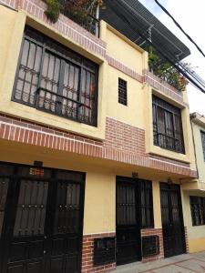 a building with black doors and black windows at Alojamiento Central Ibagué in Ibagué