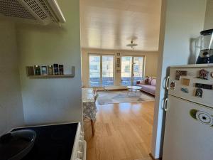 a kitchen with a refrigerator and a living room at Maria Rooms in Kuressaare