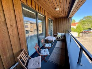 a porch with chairs and a table and a window at Maria Rooms in Kuressaare