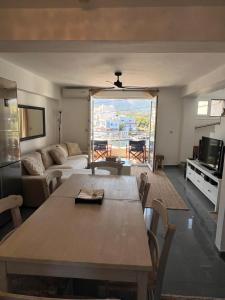 a living room with a table and a couch at Oceanview Vega in Sisi