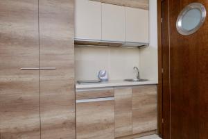 a kitchen with a sink and a cupboard at Jerry Apartment in Jastrzębia Góra