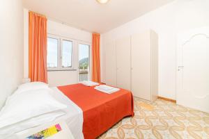 a bedroom with a bed and a large window at Residence Le Villette in Ravello +45 photos