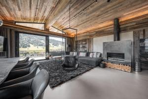a living room with a couch and a fireplace at GOING TRIPLE A apartments EAST in Going am Wilden Kaiser