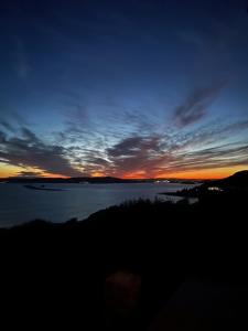 a sunset over a large body of water at Crownhill Bay House in Plymouth