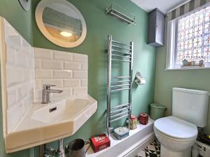 a bathroom with a sink and a toilet at Katie's Cottage in Church Stretton