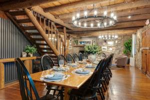 a dining room with a long table and chairs at Wildrest Hotel in Waynesville