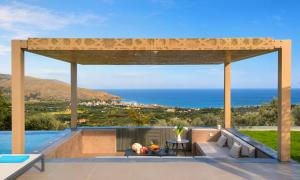 a patio with a view of the ocean at Mistral Suite Heated Pool in Georgioupoli