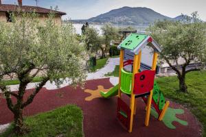 a playground with a slide in a park at Camping Eurovil in Predore