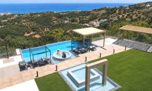 an aerial view of a house with a swimming pool at Mistral Suite Heated Pool in Georgioupoli +25 photos