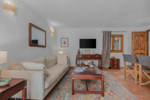 a living room with a couch and a table at Maison Magdeleine in Saint-Tropez