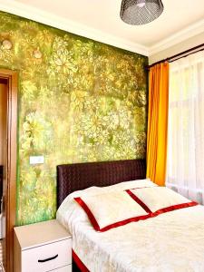 a bedroom with a bed and a green wall at Konukzade OldTown Apart in Antalya