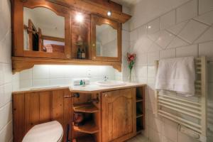 a bathroom with a sink and a mirror at Résidence Le Cristal Apartments in Chamonix