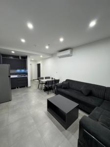 a living room with a couch and a table at Rami Grand Residence in Erbil