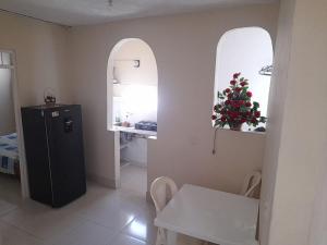 a kitchen with a black refrigerator and two arched windows at Alojamiento Central Ibagué in Ibagué