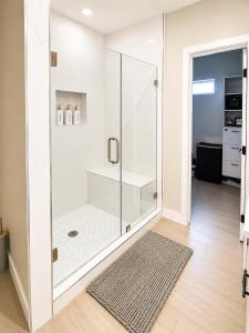 a bathroom with a shower with a glass door at Gold'n Retreat in Mission +26 photos