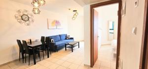 a living room with a blue couch and a table at טבריה 622 in Tiberias