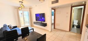 a living room with a couch and a tv at טבריה 622 in Tiberias