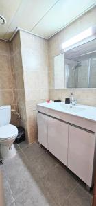 a bathroom with a toilet and a sink and a mirror at טבריה 622 in Tiberias