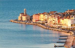 a small town on the shore of the water at Apartma Svetlo udobje v Piranu - Bright Comfort Apartment in Piran in Piran