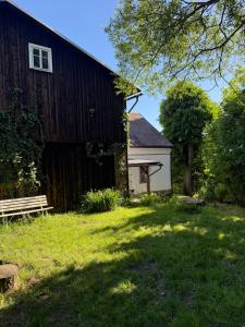 a barn with a bench in front of it at Chalupa V soukromí - Chřibská in Chřibská