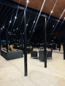 a dining area with tables and chairs and lights at HSQ Towers in Murree