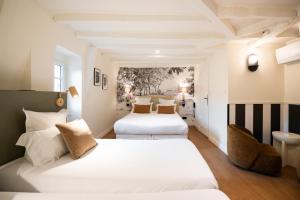 a bedroom with two beds and a sink at Hôtel La Couleuvrine Sarlat Centre Ville in Sarlat-la-Canéda +132 photos