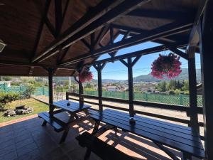 a wooden bench on a porch with a view at Casa Alexana in Gura Humorului