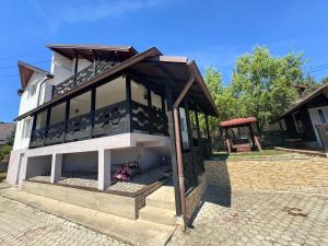 a small building with a roof on top of it at Casa Alexana in Gura Humorului
