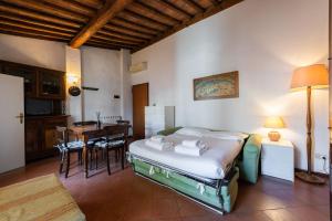 a bedroom with a bed and a table and chairs at Borgo Allegri Palace By MMega in Florence