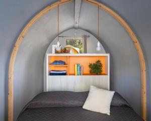 a bed in a room with an arch over it at Campeggio Iris Park in Moniga +47 photos