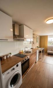 a kitchen with a washing machine in the middle at Apartamenty W Domu in Białystok