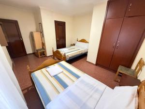 a hotel room with two beds in a room at Casa Noël in Puertollano
