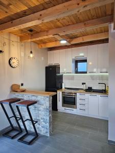 a kitchen with a counter and a sink and a stove at Brvnara Tarin osmeh - u srcu Nacionalnog parka Tara in Sekulić 