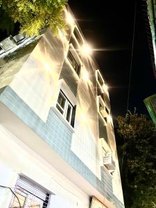 a building with blue stairs and windows at night at Shiv Dham Palace in Varanasi +18 photos