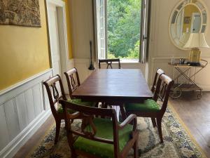 a dining room with a wooden table and chairs at Château de Saint-Pois in Saint-Pois +64 photos