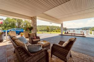 a porch with wicker chairs and a table and a car at Deerfield Inn - Virtual Check In in Hayesville