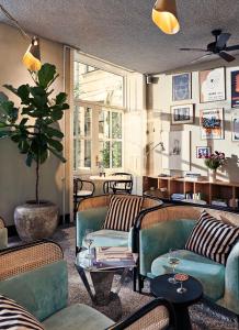 a living room with two couches and a table at Coco Hotel in Copenhagen
